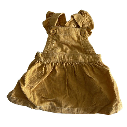 Baby Berry Age 0000 corduroy pinafore dress with ruffle straps in mustard yellow with corduroy ribbed texture, ruffle strap detail, decorative buttons — gently loved condition.