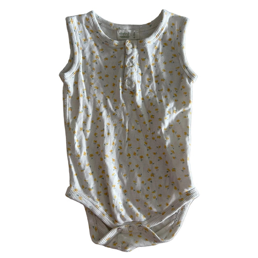 Sapling Age 0 sleeveless snap-crotch bodysuit in white, yellow with scattered small floral print — gently loved condition.