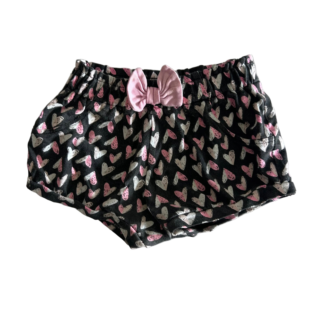 Baby Berry Age 00 shorts in dark charcoal grey, pink, white with all-over heart print, pink bow detail at front waistband — gently loved condition.