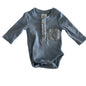Anko Age 0000 long sleeve henley bodysuit in light blue with ribbed texture, chest pocket, wooden buttons — gently loved condition.
