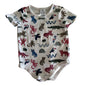 A baby short-sleeve bodysuit with an all-over animal print, laid flat on a white fabric background. The bodysuit features a white base with colorful illustrations of various animals including monkeys, birds, snakes, and cats in red, blue, brown, and black.