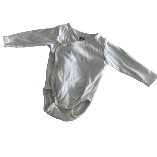 H&M Age 000 long sleeve wrap bodysuit in white with plain — gently loved condition.