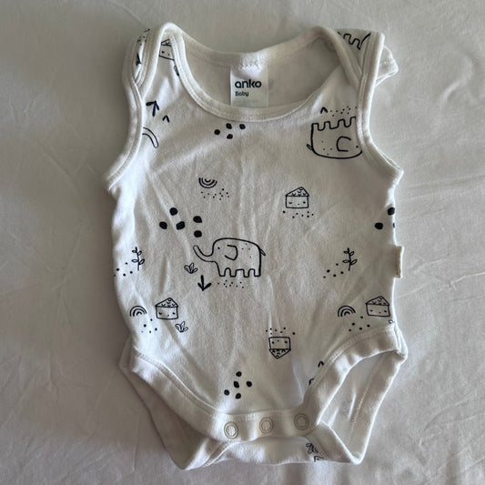 Anko Baby Age 00000 sleeveless bodysuit in white with black print with allover illustrated print featuring elephants, castles, houses, rainbows, arrows, dots and small plants — gently loved condition.