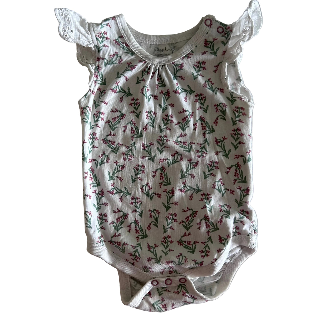 Sapling Age 0 short sleeve flutter sleeve bodysuit in white, pink, green with floral print with small pink blooms and green stems, white broderie anglaise flutter sleeves — gently loved condition.