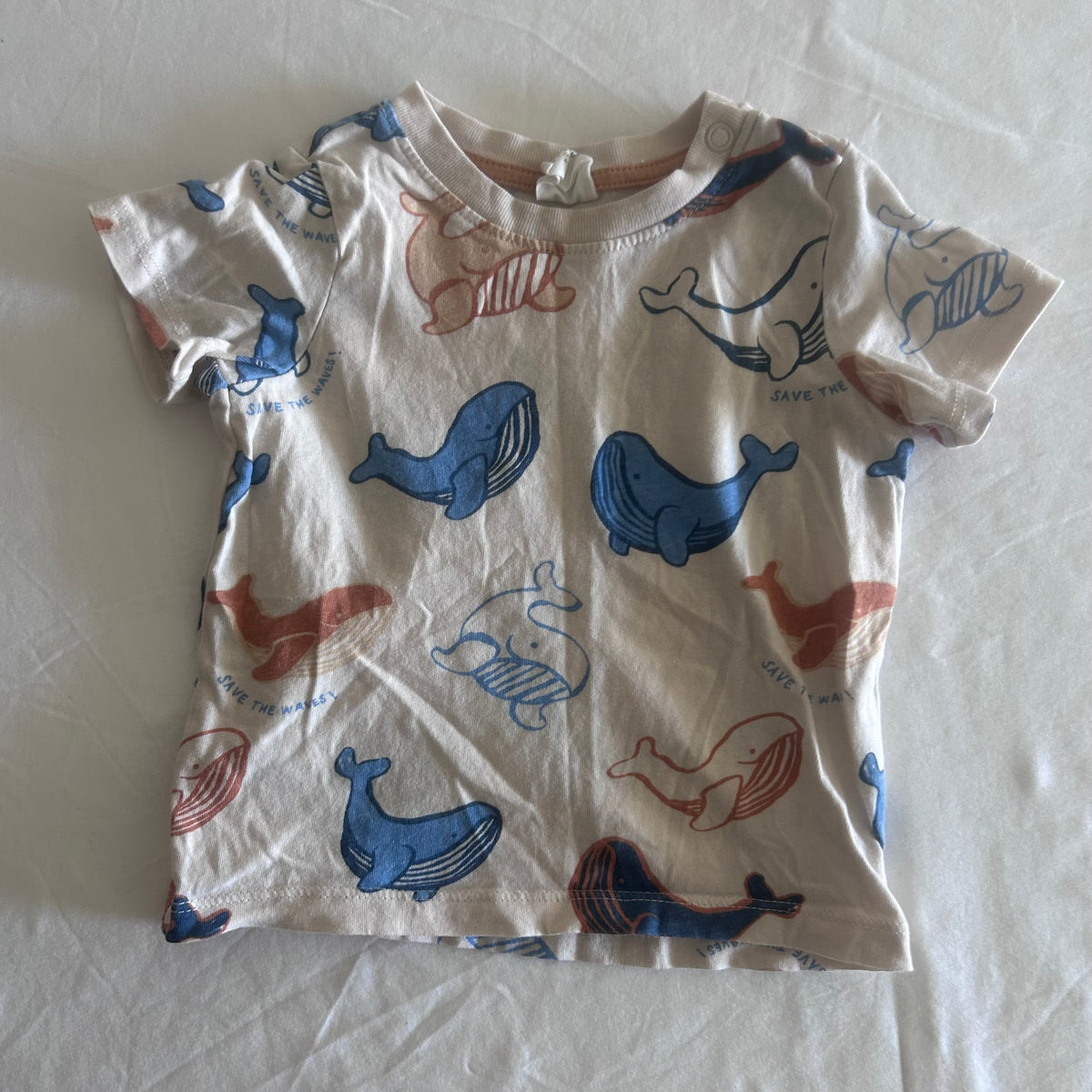 H&M Age 0 short sleeve t-shirt in white, blue, orange with all-over whale print with 'save the waves' text — gently loved condition.