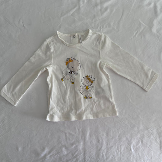 Orchestra Age 1 long sleeved top in white with two illustrated bear ballerina characters with yellow/gold bows and tulle skirt details — like new condition.