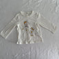 Orchestra Age 1 long sleeved top in white with two illustrated bear ballerina characters with yellow/gold bows and tulle skirt details — like new condition.
