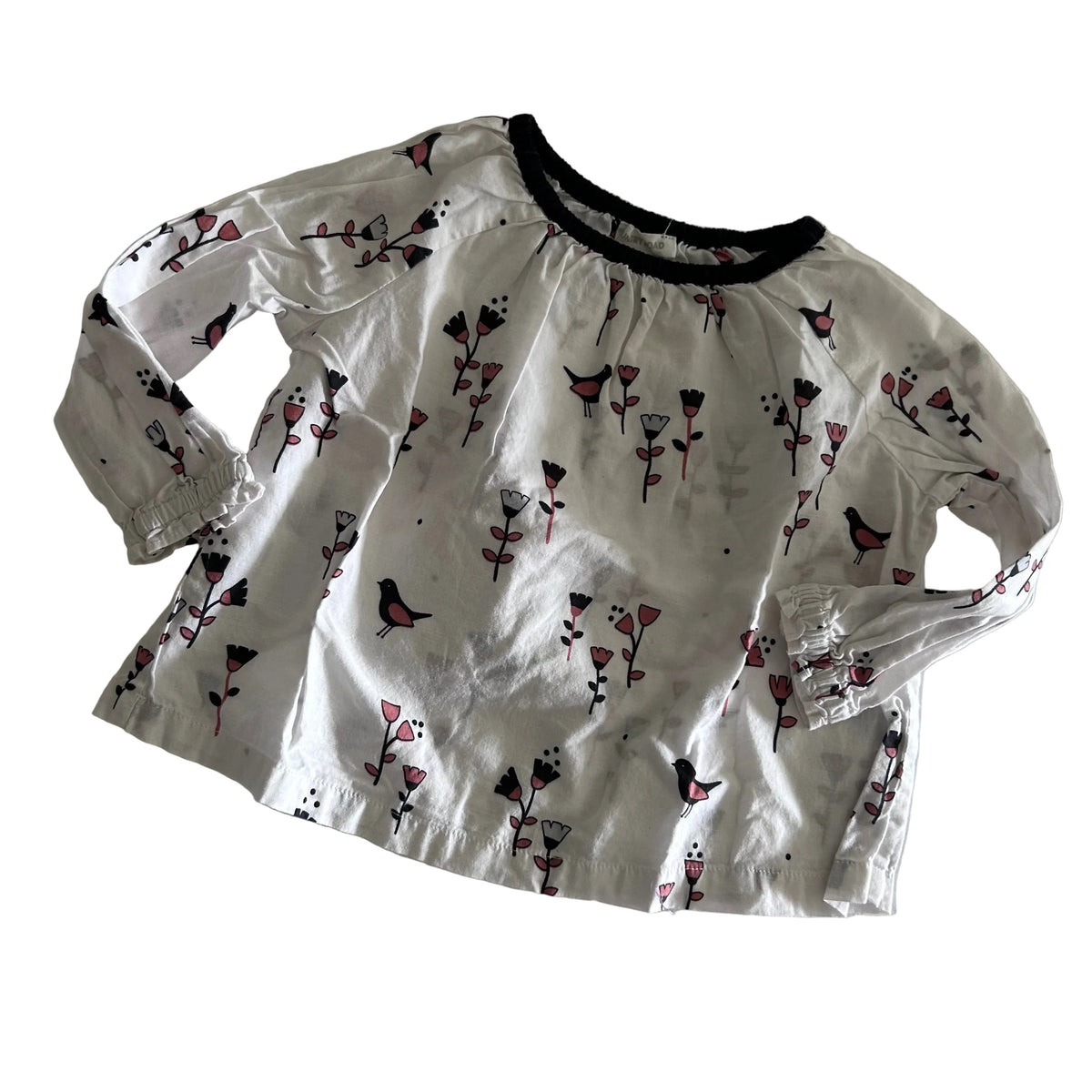 Country Road Age 1 long sleeved blouse in white, black, pink with birds and flowers print with elasticated black neckline and elasticated cuffs — gently loved condition.