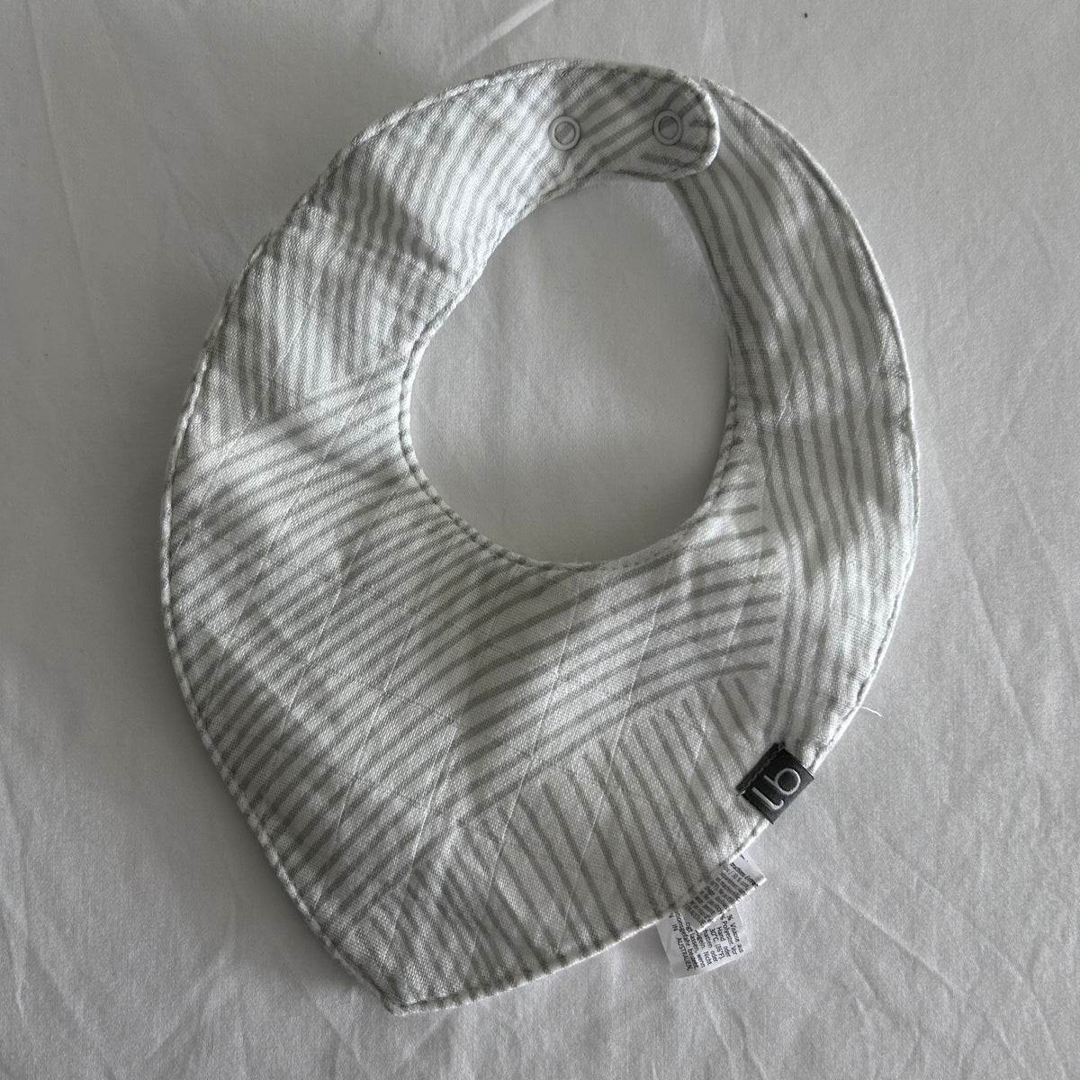Little Bamboo by The Little Linen Company Age 00 dribble bib in white and grey with diagonal stripes, quilted stitching — like new condition.