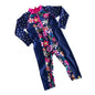 Cancer Council Age 2 long sleeve zip-up one-piece swimsuit / rashsuit in navy blue, hot pink, white, green, yellow with floral print on front and sides, white polka dots on sleeves and back, pink zip and collar trim — like new condition.