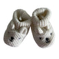 Unknown 13cm knitted baby booties in cream/off-white with bear face embroidered on toe, small ears detail, ribbed cuff — gently loved condition.