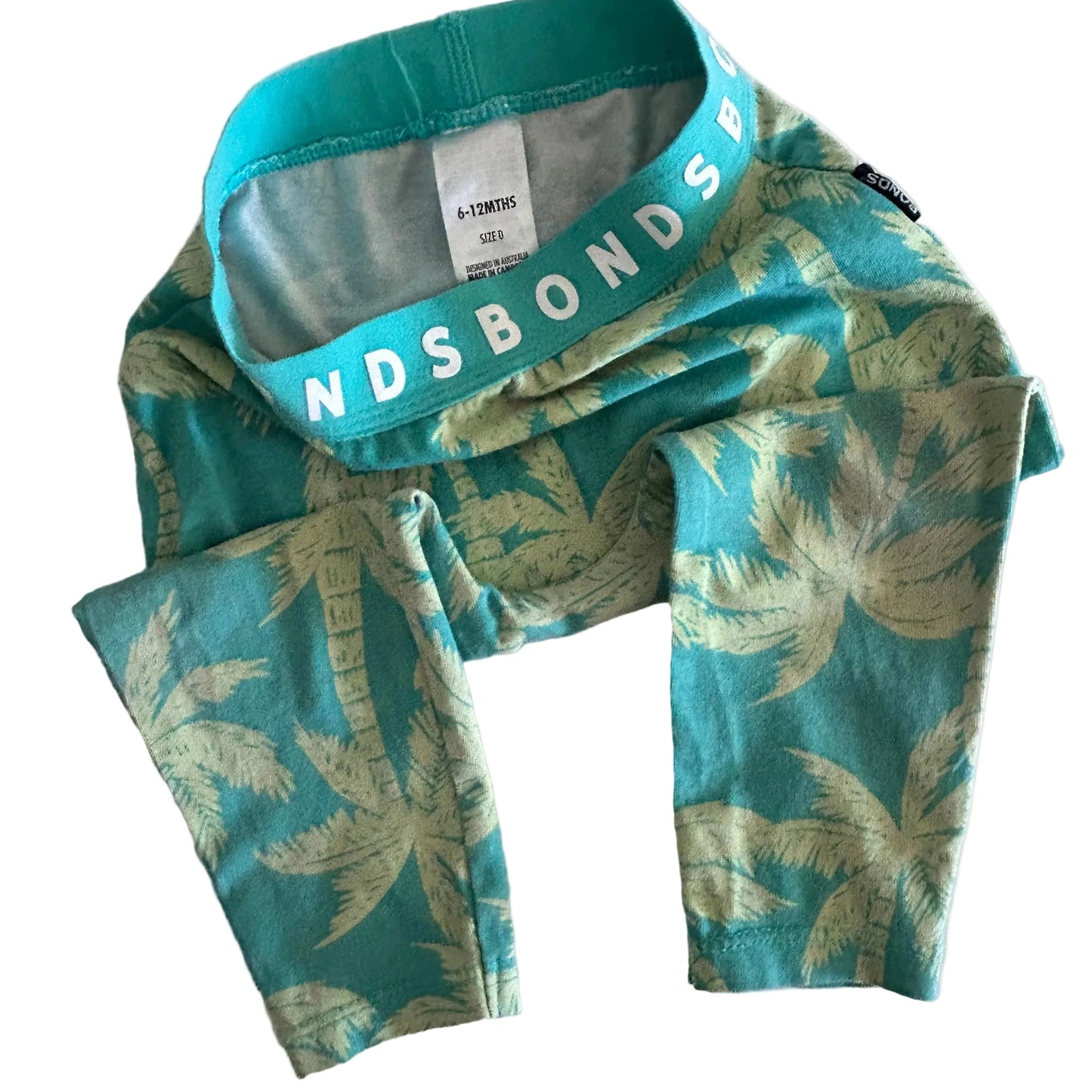 Green and yellow tropical palm tree patterned leggings with Bonds on elastic waistband and label on show
