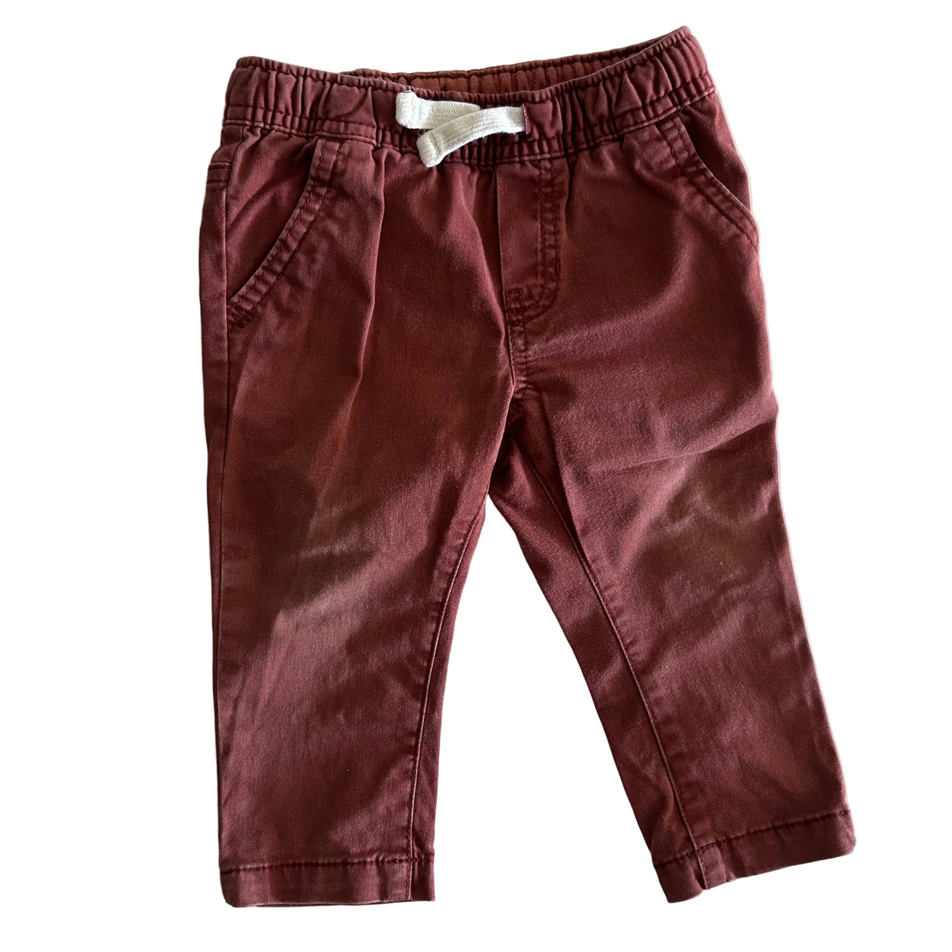 Red-brown trousers with pockets on a light background
