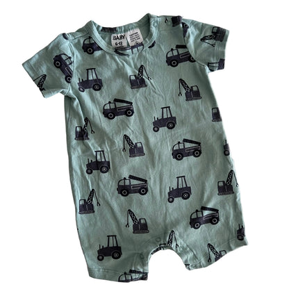 Green baby romper with black vehicle patterns on a white background