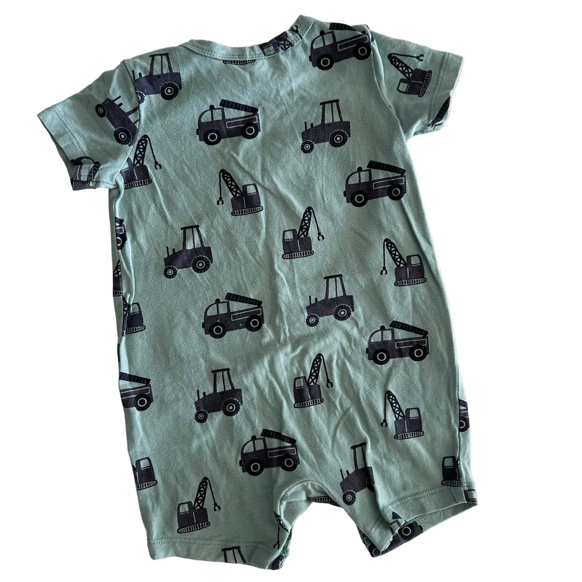 Green baby romper with black construction vehicle pattern on a white background