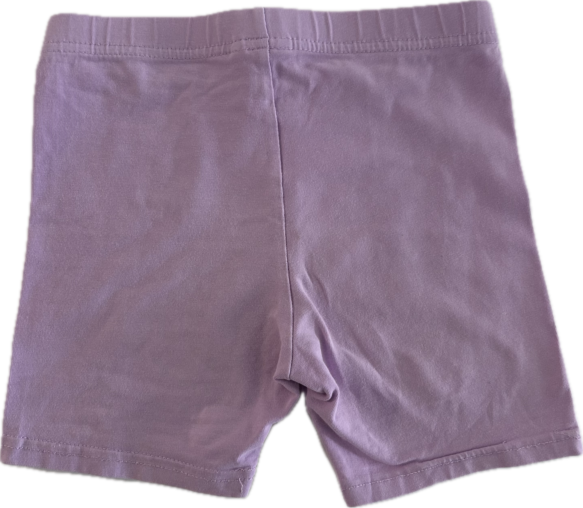 Lilac children's shorts on pale background