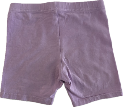 Lilac children's shorts on pale background