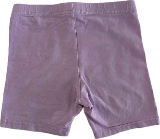 Lilac children's shorts on pale background