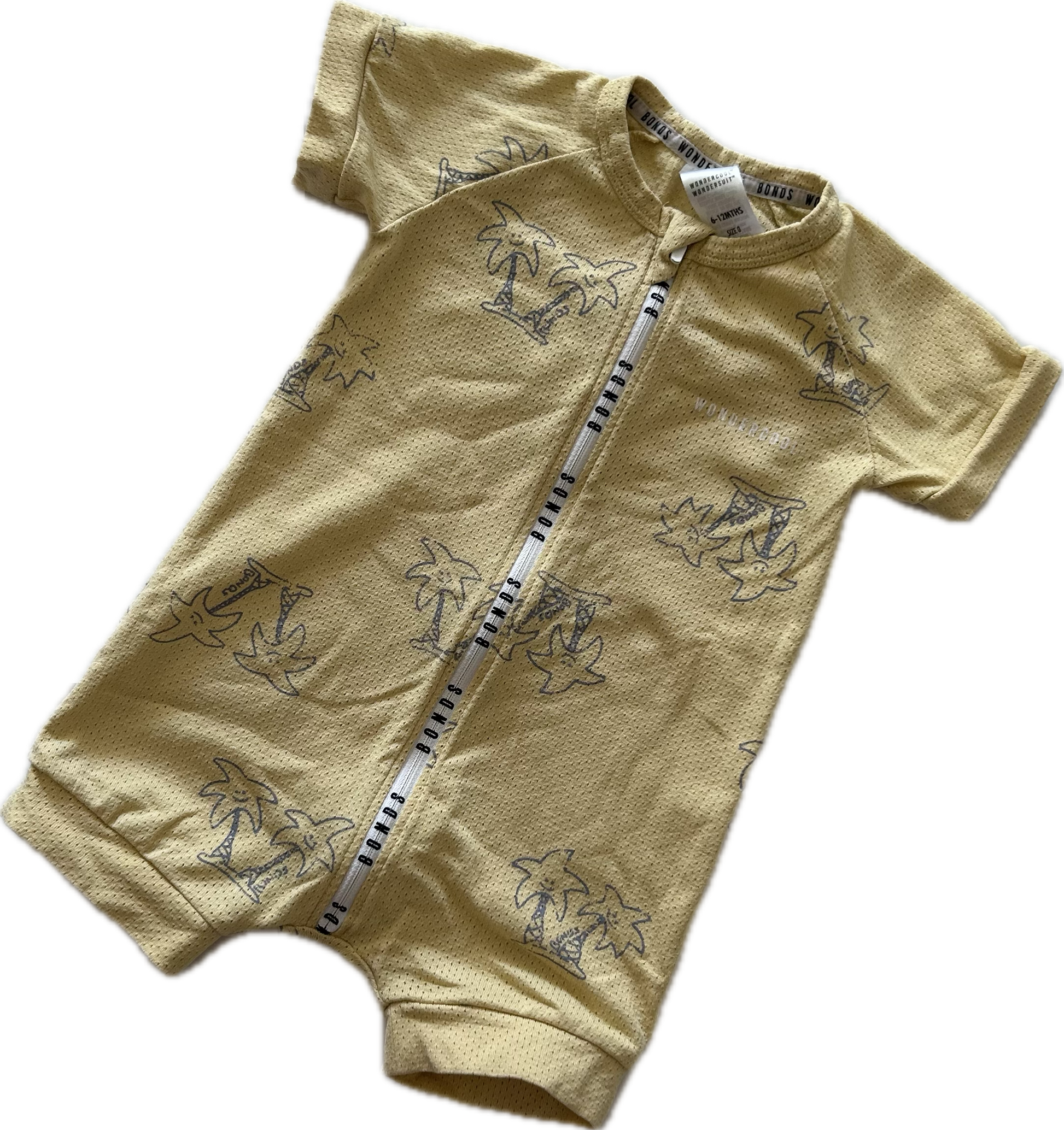 Mustard yellow baby romper with short sleeves and palm tree pattern on pale background