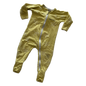 A baby's long-sleeve footed sleeper in a muted mustard yellow color, featuring a subtle tonal palm tree pattern and a white zipper with black Bonds lettering down the front