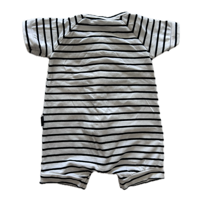 White and black stripey baby romper on pale background