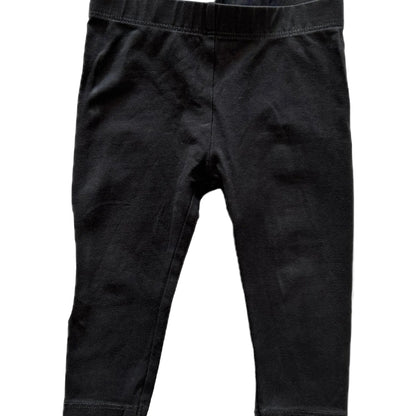 Black cotton leggings for toddlers, featuring an elastic waistband and ribbed ankle cuffs, shown flat against a white background