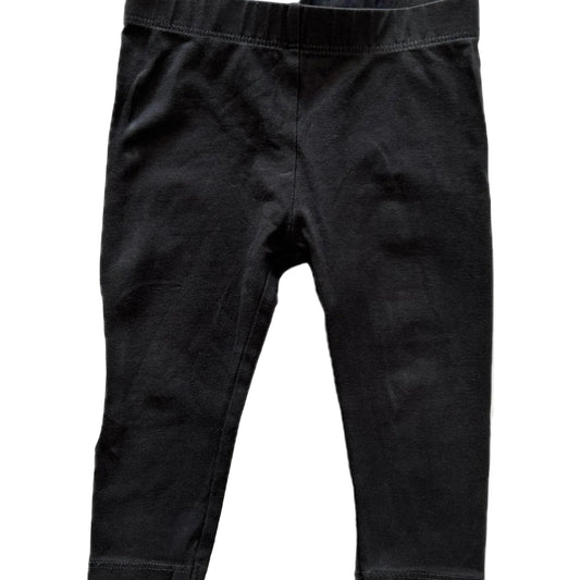 Black cotton leggings for toddlers, featuring an elastic waistband and ribbed ankle cuffs, shown flat against a white background
