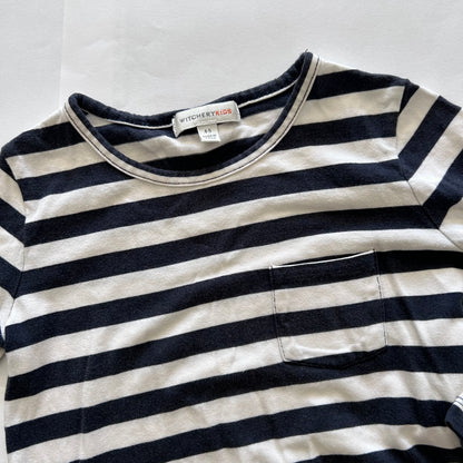 A close-up of a children's long-sleeve striped shirt with a chest pocket, featuring navy blue and off-white horizontal stripes. The brand label 'WITCHERY KIDS' is visible inside the collar.
