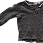 A dark gray-brown ribbed knit long-sleeve shirt with a three-button placket and a chest pocket, laid flat against a white background.