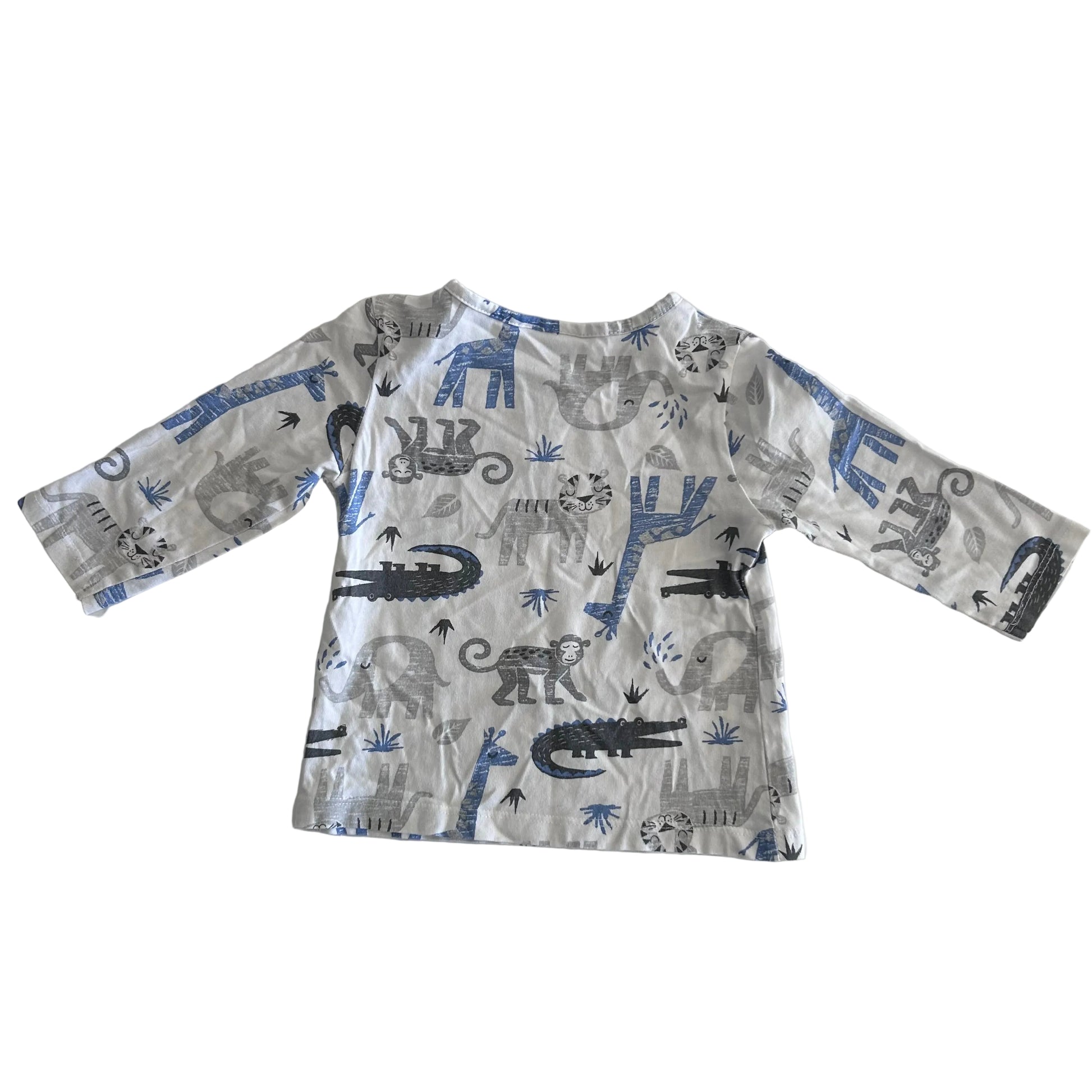 A long-sleeve baby t-shirt with an all-over safari animal print, laid flat on a white background. The print features blue giraffes, gray crocodiles, and black monkeys on a white base.
