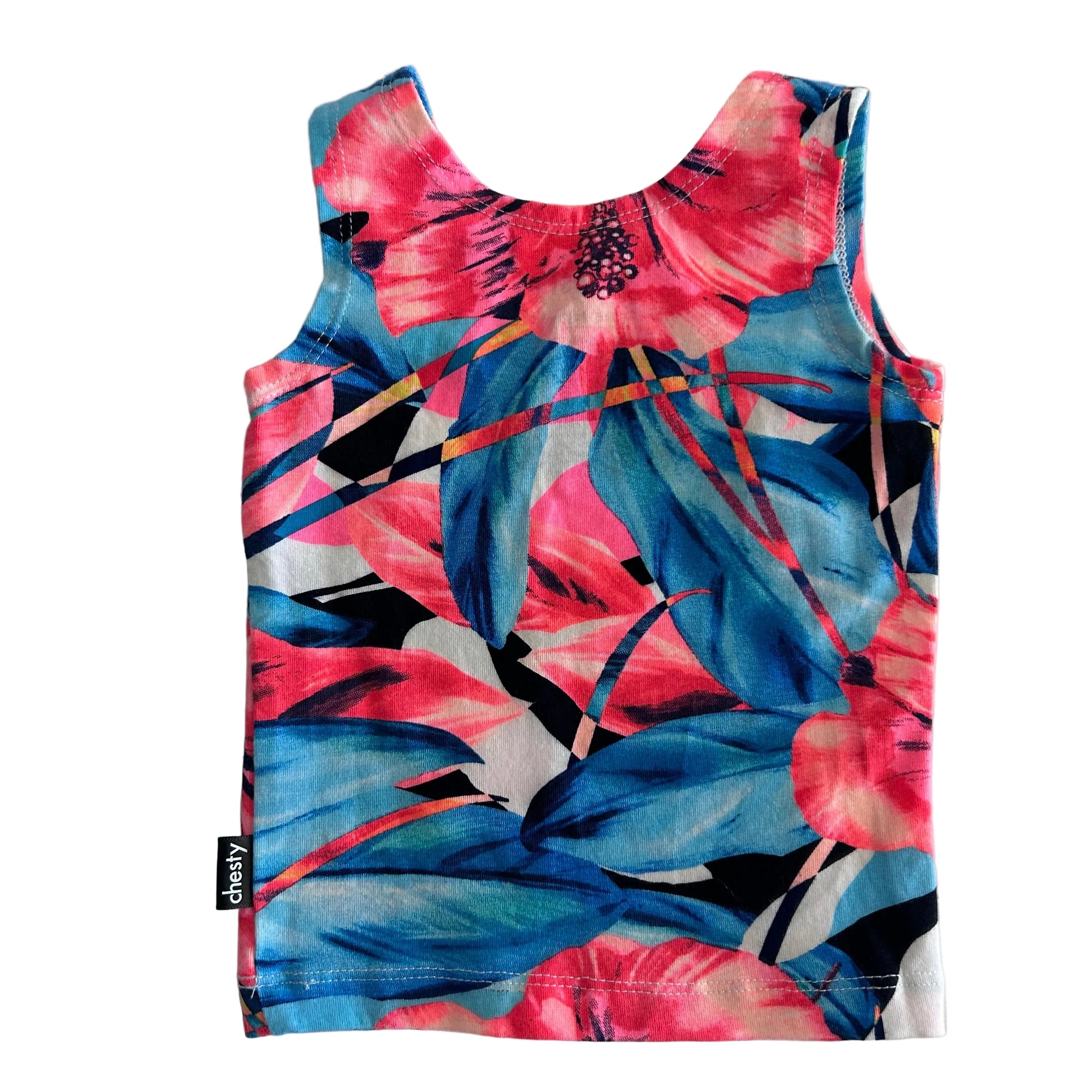 A sleeveless tank top with a vibrant tropical floral and leaf print in pink, blue, and white, laid flat on a light gray background. A small black fabric tag on the bottom left reads 'chesty'.