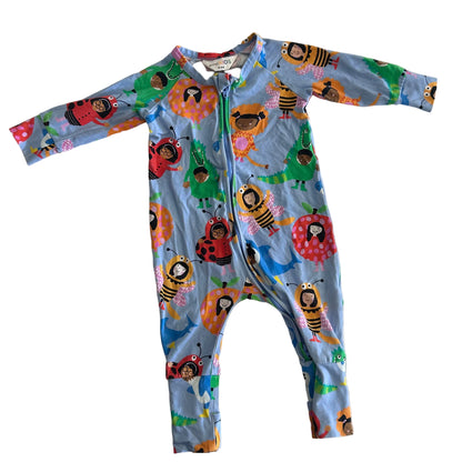 A baby's long-sleeve zip-up one-piece romper in light blue, featuring a colorful cartoon print of ladybugs, bees, flowers, and children, laid flat on a white background.