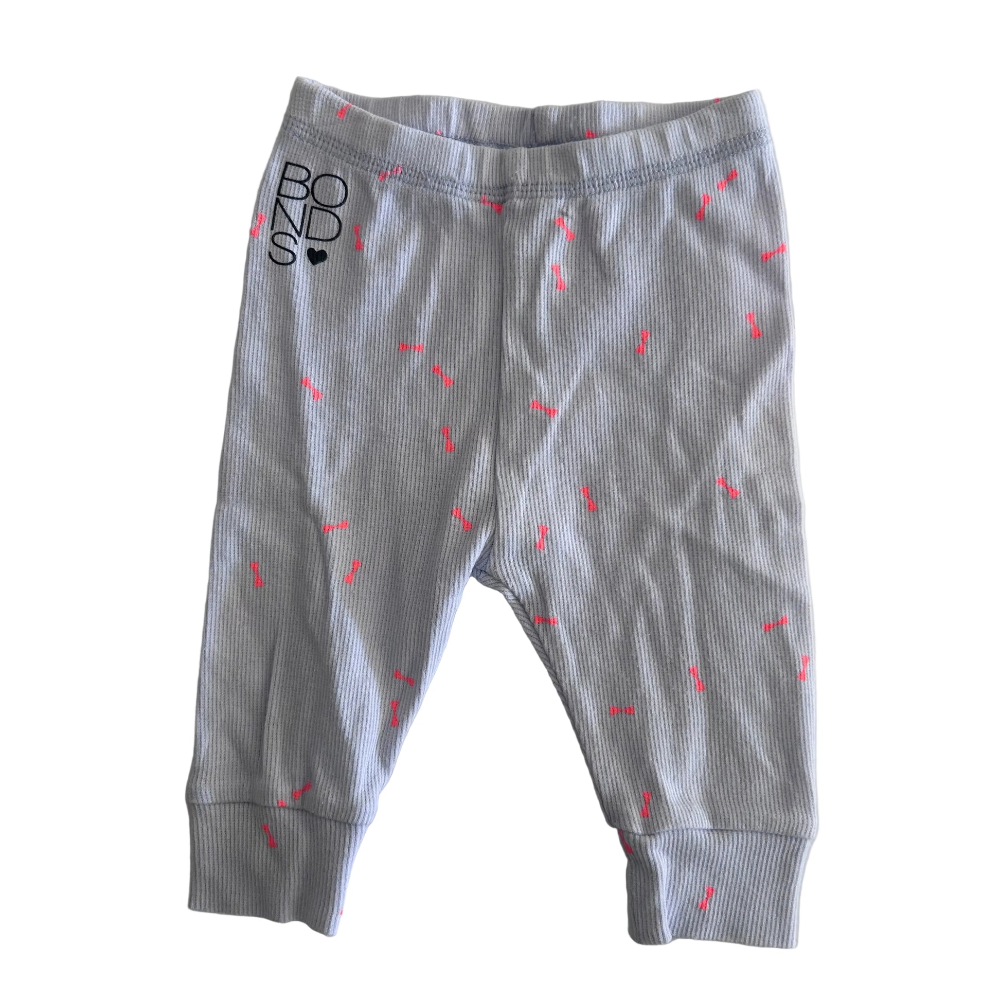 A pair of baby leggings in lilac ribbed fabric with small pink dash patterns and a black 'BONDS' logo on the left hip, laid flat on a light background.