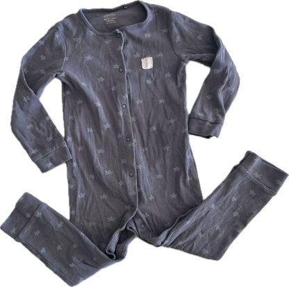 A button up onesie laid flat on a white background, featuring long sleeves, legs folder upwards, purple grey colour and stars and crescent moon pattern.
