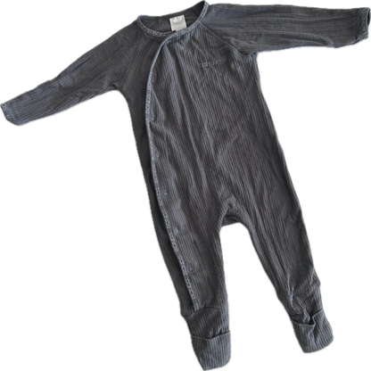 A dark gray ribbed baby romper with long sleeves and footed legs, laid flat on a white background.