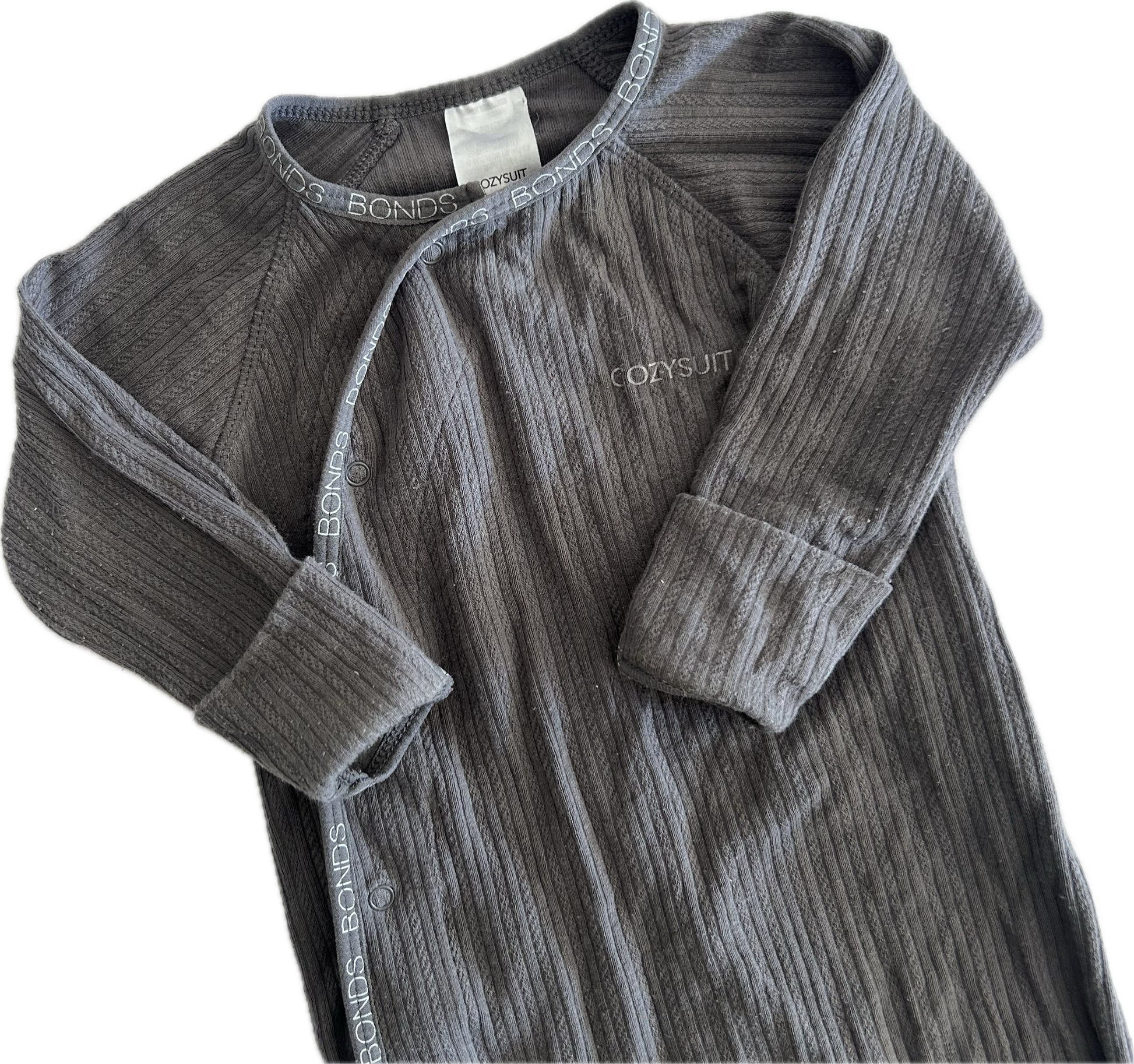 The top half of a dark gray ribbed long-sleeve baby onesie, featuring a snap-button front and a small white embroidered 'Cozysuit' logo on the chest, laid flat on a white background.