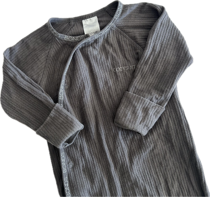The top half of a dark gray ribbed long-sleeve baby onesie, featuring a snap-button front and a small white embroidered 'Cozysuit' logo on the chest, laid flat on a white background.
