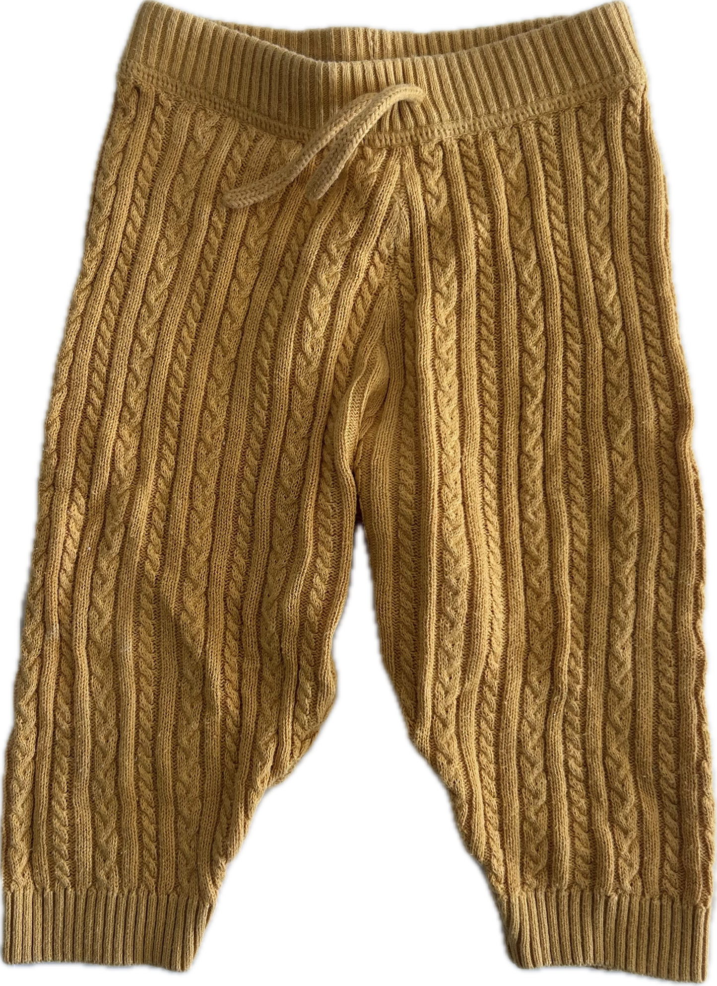 A pair of mustard yellow cable-knit baby pants with an elastic waistband and drawstring, shown against a plain white background.