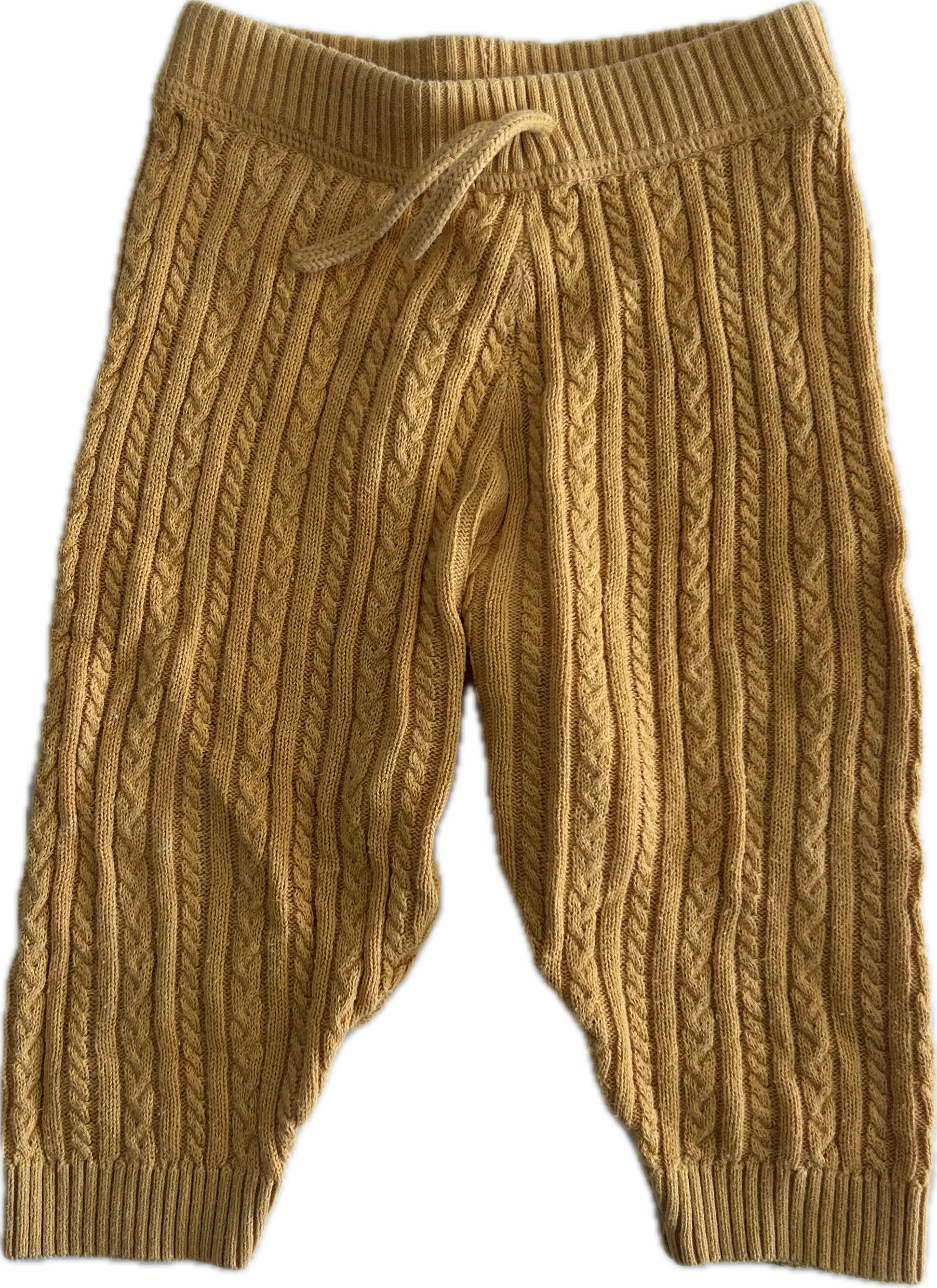 A pair of mustard yellow cable-knit baby pants with an elastic waistband and drawstring, shown against a plain white background.