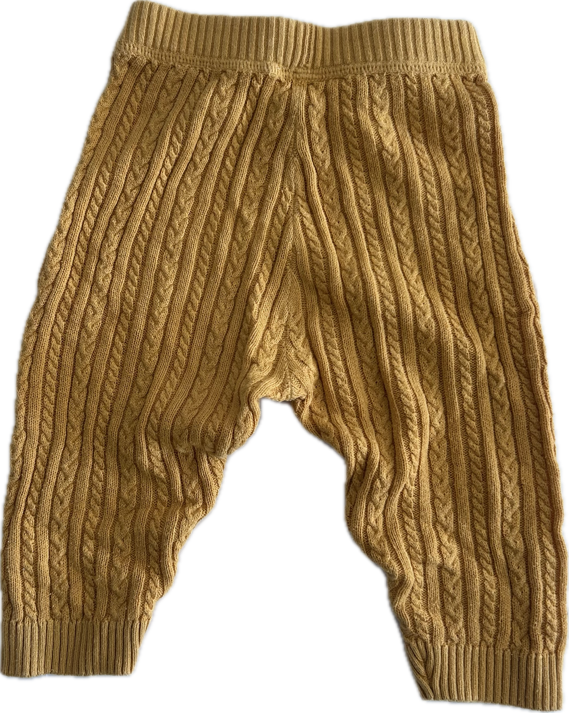 A pair of mustard yellow cable-knit baby pants with a wide elastic waistband and ribbed ankle cuffs, shown against a plain white background.