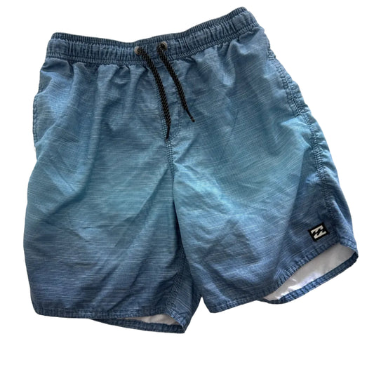 A pair of boy's light blue denim swim trunks with a black drawstring and a small black brand patch, laid flat on a white fabric background.