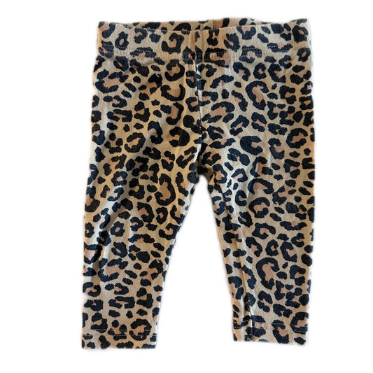 A pair of toddler leggings with a classic leopard print pattern in beige, brown, and black, laid flat against a white background.