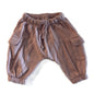 A pair of dusty brown harem-style cargo pants for toddlers, featuring an elastic waistband with a drawstring, side cargo pockets, and elastic cuffs, laid flat on a white background.