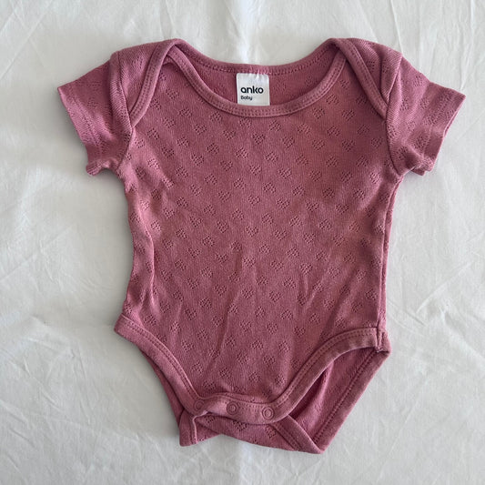 Anko Age 000 short sleeve bodysuit in dusty pink with pointelle knit diamond texture â€” like new condition.