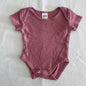 Anko Age 000 short sleeve bodysuit in dusty pink with pointelle knit diamond texture â€” like new condition.