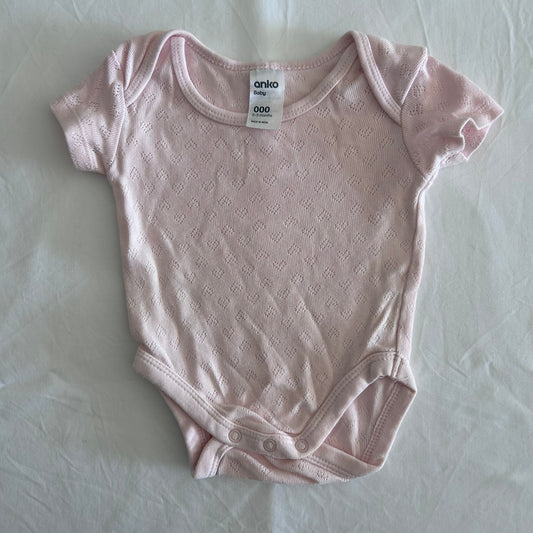 Anko Age 000 short sleeve bodysuit in pink with pointelle knit diamond texture â€” gently loved condition.