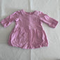 Sprout Age 000 long sleeve bubble dress in pink with plain with gathered skirt, ruffle cuffs, and back snap button placket â€” gently loved condition.