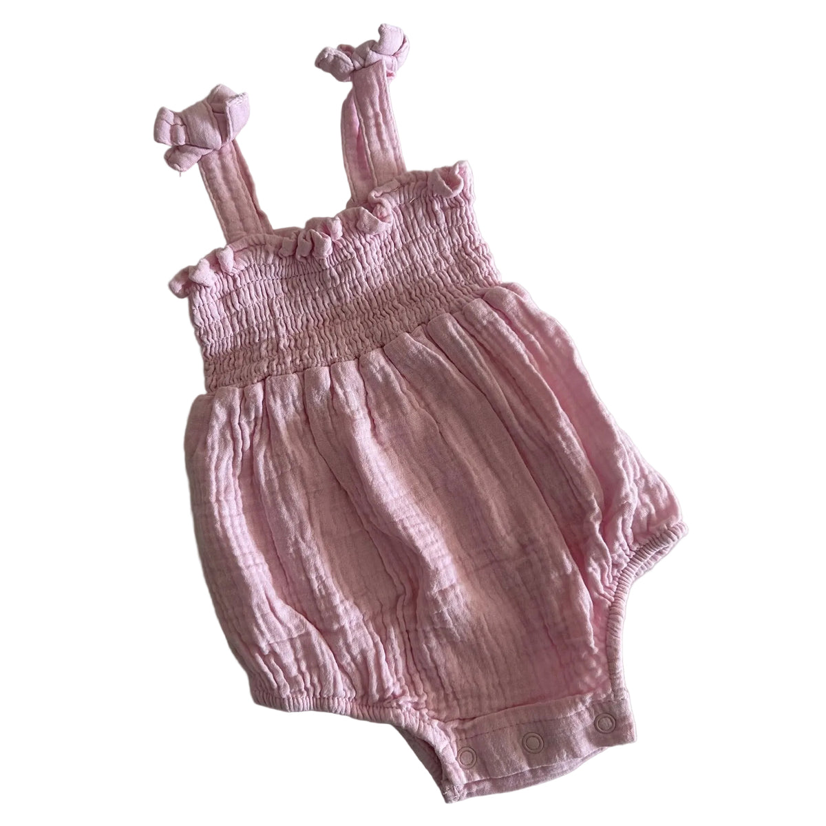 Dymples Age 000 romper in pink with smocked bodice with ruffle trim and tie shoulder straps â€” gently loved condition.