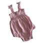 Dymples Age 000 romper in pink with smocked bodice with ruffle trim and tie shoulder straps â€” gently loved condition.