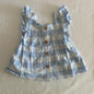 Dymples Age 000 dress in light blue and white with large gingham check, ruffle straps, front button placket with wooden buttons, gathered skirt â€” gently loved condition.